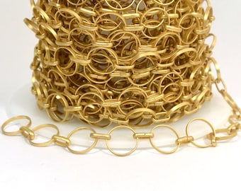 May include: A roll of gold-colored metal chain with a close-up of a section of the chain. The chain is made of interlocking oval links.