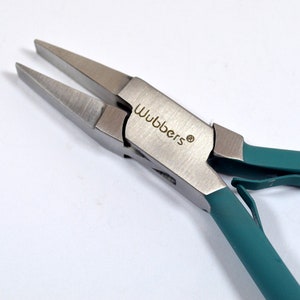 May include: Close-up of a pair of teal-colored pliers with a silver metal head. The pliers are labeled "Wubbers" on the head.