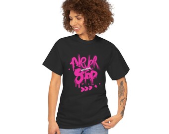 May include: Black t-shirt with the words "Never Stop Dreaming" in bright pink graffiti-style lettering. The design includes dripping paint effects and directional arrows. The shirt is made of a soft material.