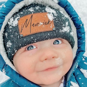 infant wearing charcoal heather beanie with personalized caramel patch and matte black rivets