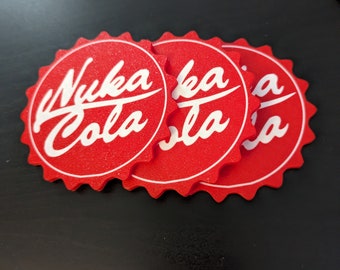 May include: Four red and white Nuka Cola bottle cap coasters. The coasters are made of foam and have a raised edge.
