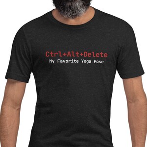 May include: A black t-shirt with a white graphic that says "Ctrl+Alt+Delete My Favorite Yoga Pose" in red text.
