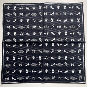 May include: Black and white patterned bandana with a white polka dot background. The pattern includes shoes, bows, mirrors, crowns, and aeroplanes. The text "Love & Goodness" is repeated throughout the bandana.