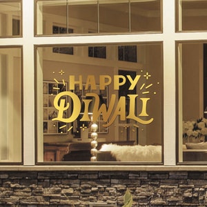 May include: A gold window decal with the text "Happy Diwali" in a decorative font. The decal is on a window of a house with a stone exterior.