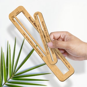 May include: Two brown cardboard rulers with cutouts for measuring the maximum size of envelopes for Royal Mail postage. The rulers are labeled "Royal Mail Small Letter Guide" and "Royal Mail" with the maximum size and weight for each type of envelope.