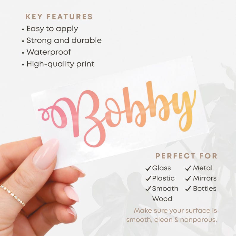 May include: A white sticker with the name "Bobby" in a gradient of pink and orange. The sticker is easy to apply, strong, durable, waterproof, and has a high-quality print. Perfect for glass, metal, plastic, mirrors, smooth surfaces, and bottles.