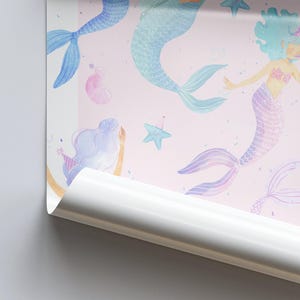 May include: Pink wallpaper featuring watercolor illustrations of mermaids with blue, purple, and teal tails. The mermaids have light blue and purple hair, and some wear party hats. Starfish and bubbles are also scattered across the design.