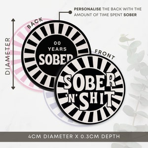 May include: Black and white round coaster with the text "SOBER N' SHIT" on the front and "00 YEARS SOBER" on the back. The coaster is 4 inches in diameter and 0.3 inches deep.