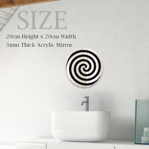 May include: A black and white spiral design acrylic mirror with a 20cm height and 20cm width. The mirror is 3mm thick.