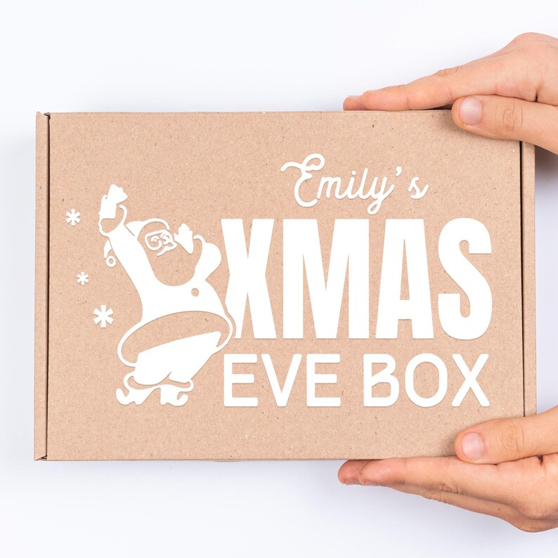 May include: A brown cardboard box with a white design featuring a cartoon Santa Claus, the text "Emily's Xmas Eve Box", and snowflakes.