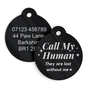May include: Two black round pet ID tags. The first tag has a phone number, address, and postcode. The second tag has the text "Call My Human" with stars and the text "They are lost without me".