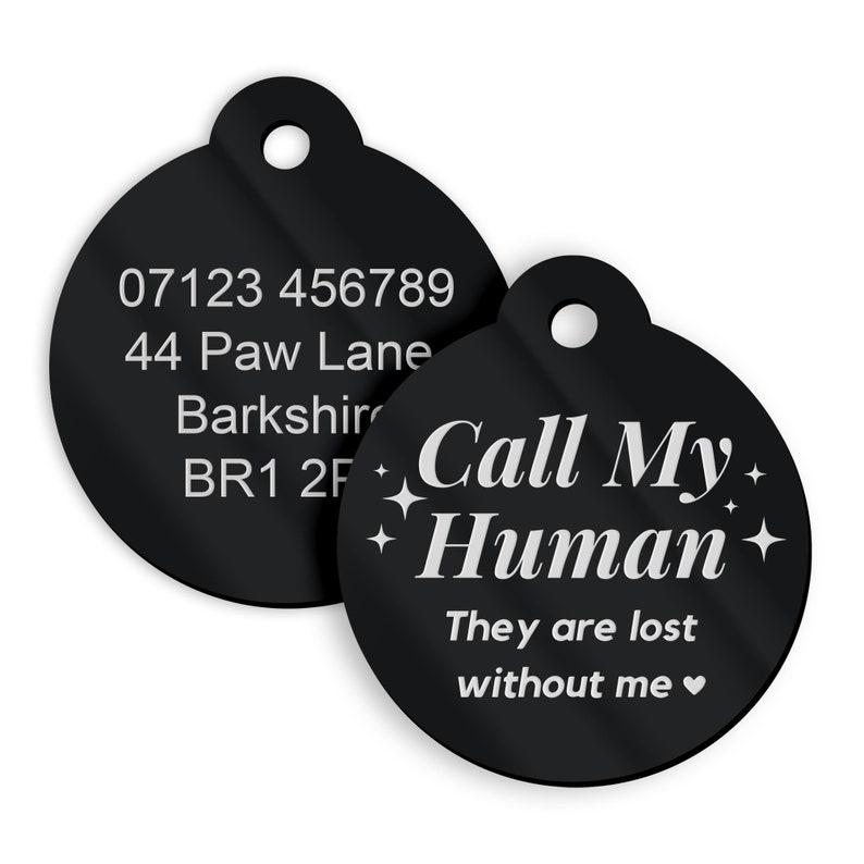 May include: Two black round pet ID tags. The first tag has a phone number, address, and postcode. The second tag has the text "Call My Human" with stars and the text "They are lost without me".