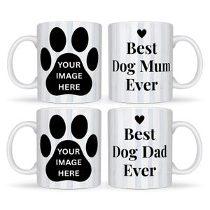 May include: Four white ceramic mugs. Two mugs feature a black paw print with the text "YOUR IMAGE HERE". The other two mugs have the text "Best Dog Mum Ever" and "Best Dog Dad Ever" with a black heart. The mugs have a white background with blue vertical stripes.