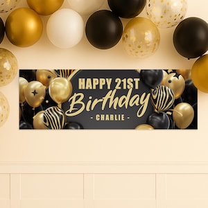 May include: A banner with the text "HAPPY 21ST Birthday - CHARLIE -" in gold lettering, surrounded by black, gold, and white balloons. The balloons are of various sizes and designs, creating a festive atmosphere.