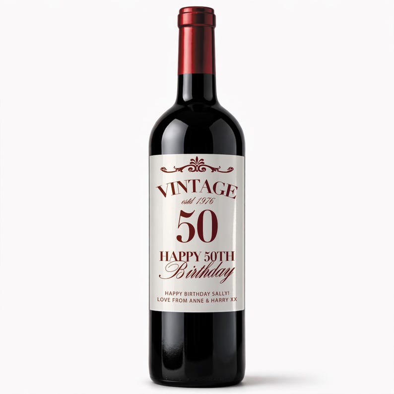 May include: A dark red wine bottle with a white label. The label reads "VINTAGE estd 1976 50 HAPPY 50TH BIRTHDAY" in burgundy lettering. The bottle is a birthday gift with a personalized message.