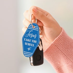 May include: Blue motel key chain with the text "Jesus Take the Wheel" and a white star.