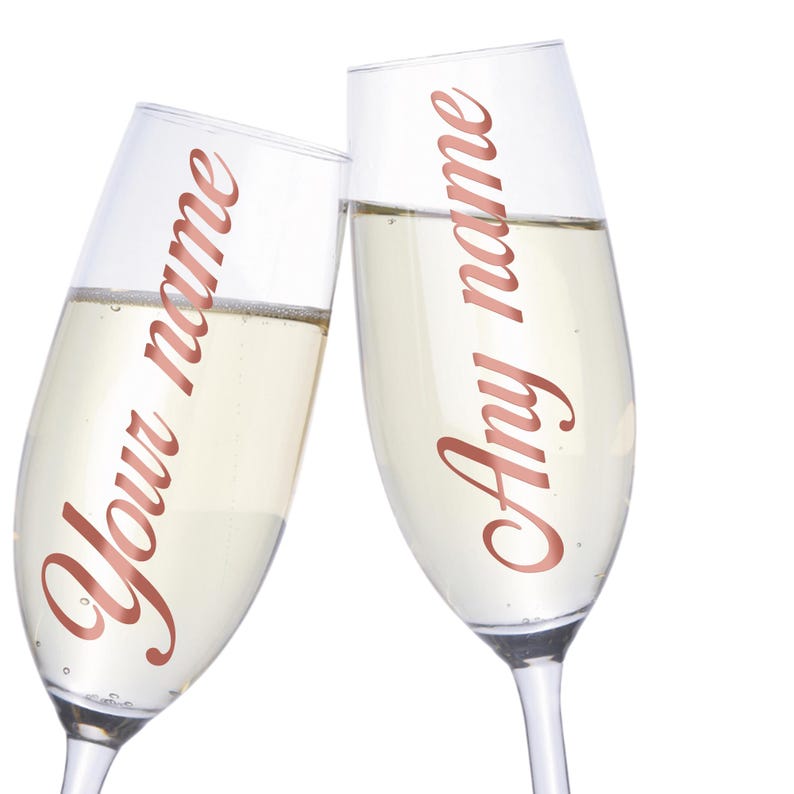 May include: Two champagne flutes with personalized names, "Your name" and "Any name", written in a rose gold font.