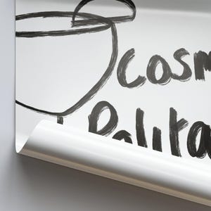 May include: A white surface with black marker writing that says "cosmetics" and "Balita". A black marker drawing of a cup is in the top left corner of the image.