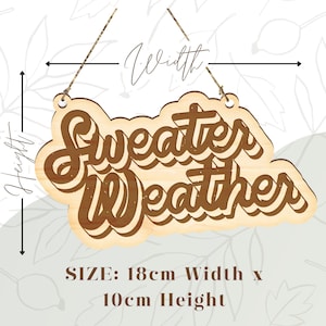 May include: Wooden sign with the words "Sweater Weather" in a layered, brown, cursive font. The sign is 18cm wide and 10cm high, with a light wood grain finish. It has a decorative shape and a string for hanging.