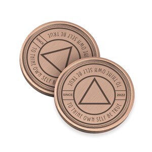 May include: Two copper-colored coins with the inscription "To thine own self be true" and a triangle design. The inscription "Since 2022" appears on one of the coins.