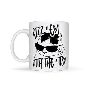 May include: White ceramic mug featuring a black and white illustration of a cat wearing sunglasses and the text "Rizz 'em with the 'tism" printed on it.