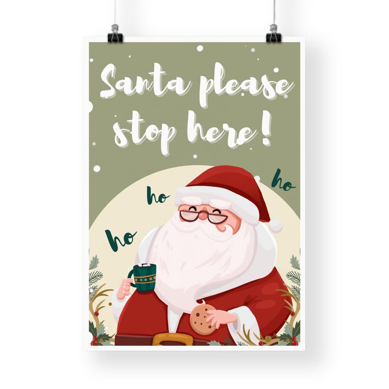 May include: A green and white Christmas sign with Santa Claus holding a cup of hot chocolate and a cookie. The sign says "Santa please stop here!" with "ho ho ho" written around Santa.
