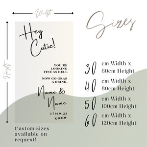 May include: A white and green poster with the text "Hey Cutie!" and "You're looking fine as hell. Now go grab a drink. Name & Name 17109123 xoxo". The poster also includes a size chart with the following sizes: 30 cm x 60 cm, 40 cm x 80 cm, 50 cm x 100 cm, and 60 cm x 120 cm.