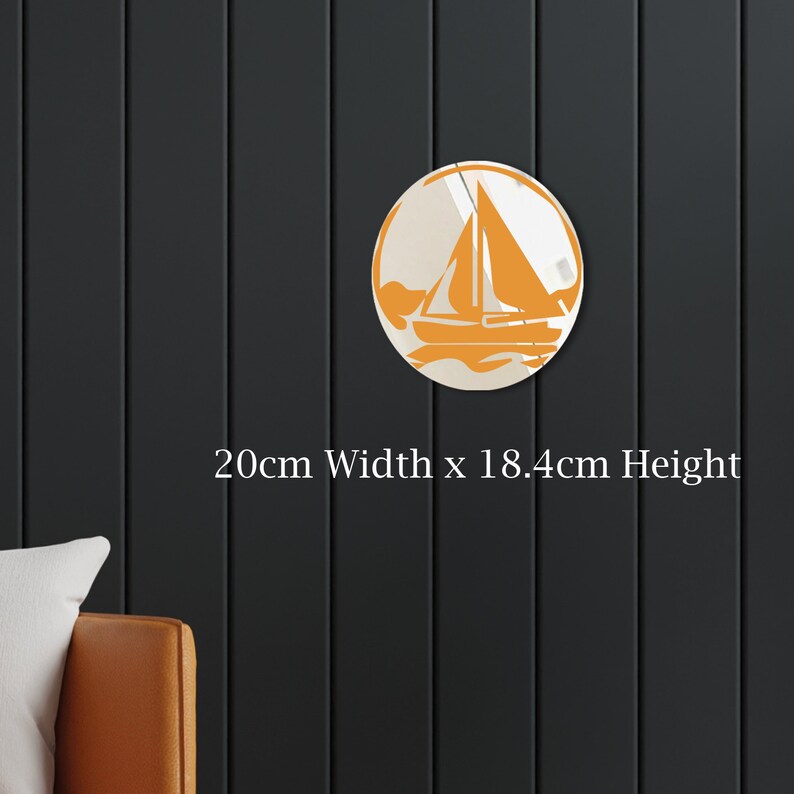 May include: A round, white wall decor with an orange sailboat design. The decor measures 20cm wide by 18.4cm high.