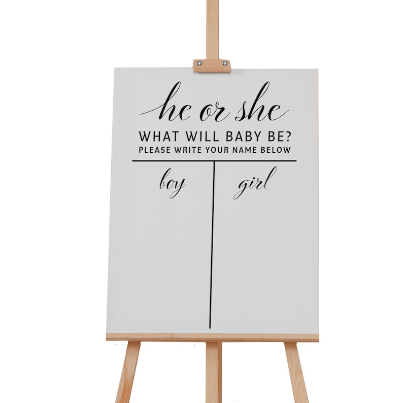 May include: A white sign with black text that reads "he or she WHAT WILL BABY BE? PLEASE WRITE YOUR NAME BELOW" with a line down the middle and the words "boy" and "girl" written on either side.