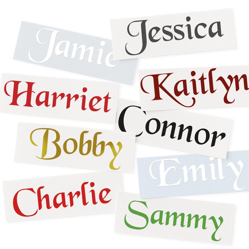 May include: A collection of name decals in various colors and fonts. Names include Jamie, Jessica, Harriet, Kaitlyn, Connor, Bobby, Charlie, Emily, and Sammy. The decals are on rectangular white backgrounds.