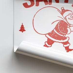 May include: Red and white distressed graphic of Santa Claus carrying a bag of gifts. The graphic includes the text "SANTA".