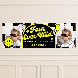 May include: A personalized birthday banner with the text "Four Ever Wild!! Happy 4th Birthday Jackson" in yellow and black. The banner includes a photo of a child wearing sunglasses, a smiley face, a dice, and a hand gesture.