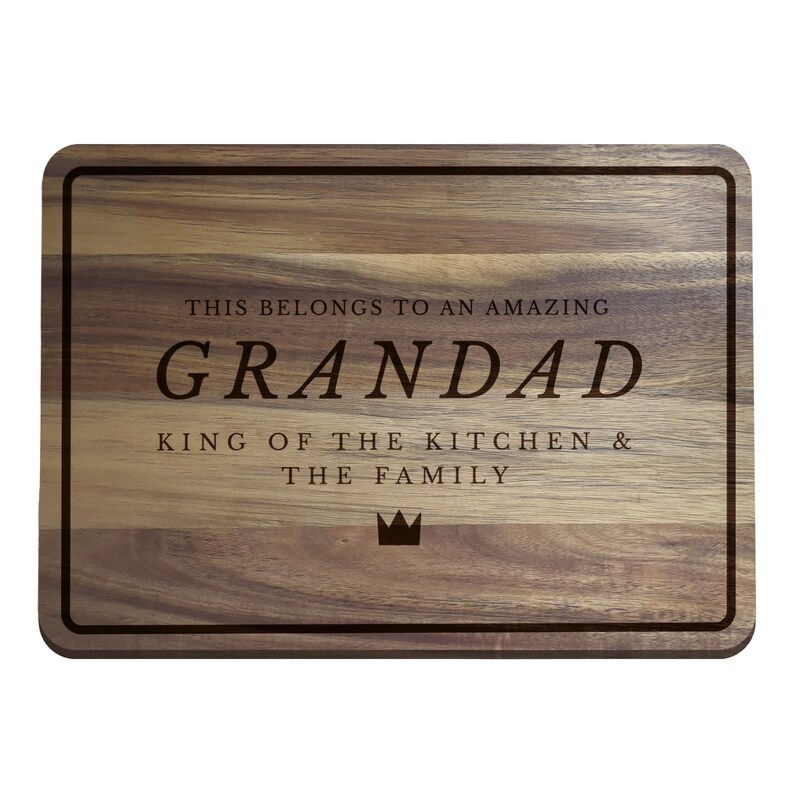 May include: A brown wooden cutting board with a black border and the text "This belongs to an amazing Grandad, King of the Kitchen & the Family" with a crown symbol.
