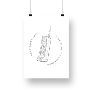 May include: A black and white illustration of a vintage cell phone with the text "Don't drunk call your ex in the bathroom" around it.