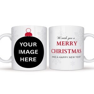 May include: White ceramic mug with a Christmas theme. One side features a black ornament design with the text "YOUR IMAGE HERE". The other side has the text "We wish you a MERRY CHRISTMAS AND A HAPPY NEW YEAR" in red.