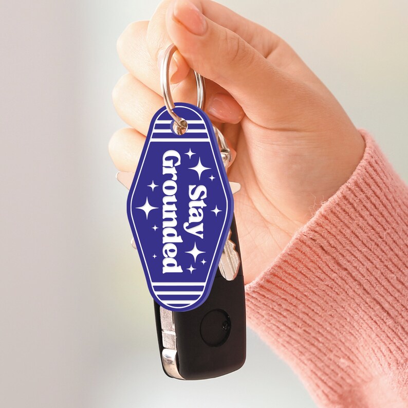 May include: Blue key chain with a white star design and the text "Stay Grounded".