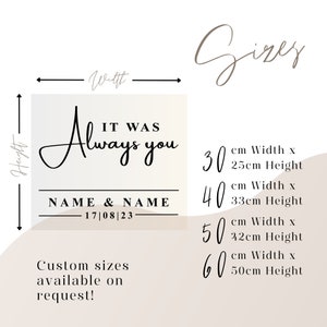 May include: A white background with a black and white graphic design that says "It Was Always You" with the option to add names and a date. The graphic is surrounded by a black border. Below the graphic, the text "Custom sizes available on request!" is displayed. The image also shows a size chart with four different sizes: 30 cm x 25 cm, 40 cm x 33 cm, 50 cm x 42 cm, and 60 cm x 50 cm.