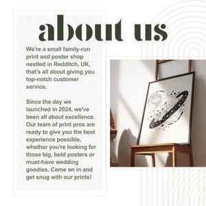 May include: A black and white illustration of a cat sitting on a planet with stars and the text "It's your time to shine and to explore". The illustration is framed and hanging on a wooden easel.