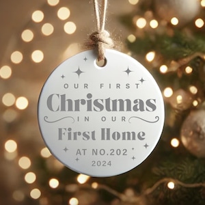 May include: White ceramic Christmas ornament with the text "Our First Christmas in Our First Home At No. 202 2024".