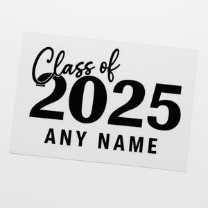 May include: A white rectangular sign with black text. The words "Class of" are in a cursive font above the large numbers "2025". Below the numbers, the words "ANY NAME" are printed in a sans-serif font.
