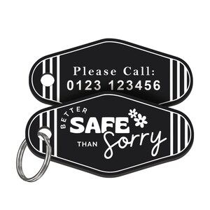 May include: Black and white key chain with a black diamond-shaped tag that says "Better Safe Than Sorry" with a flower graphic. The other side of the tag has a phone number that says "Please Call: 0123 123456".