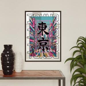 May include: A colorful print of a Tokyo cityscape with the Japanese characters for "Tokyo" in black against a pink and blue neon background. The print is framed in a black frame.