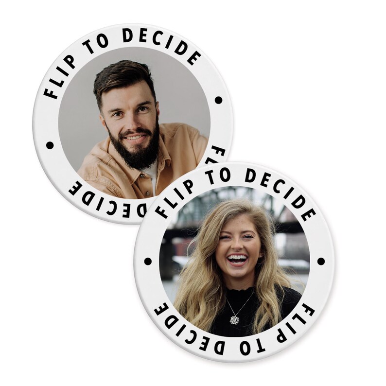 May include: Two white circular buttons with the text "FLIP TO DECIDE" around the edge. Each button features a person's portrait. One button shows a man with a beard, and the other shows a woman smiling.