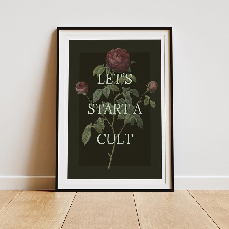 May include: A black and white framed print with a dark green background featuring a stylized illustration of a rose bush with the text "Let's start a cult" in white.