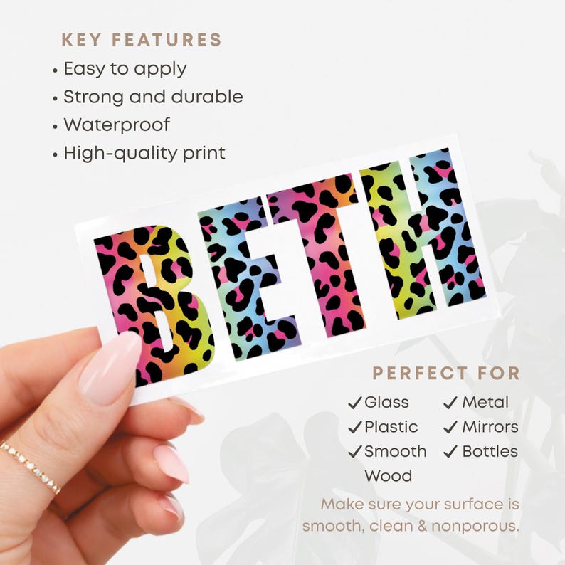 May include: A rectangular sticker with the name "BETH" in large, bold letters. The letters are filled with a colorful leopard print pattern in shades of pink, yellow, blue, and black. The sticker is designed for use on glass, metal, plastic, mirrors, smooth wood, and bottles.
