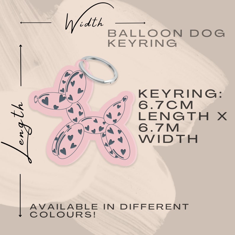 May include: A pink balloon dog keyring with a silver ring. The dog is decorated with dark gray hearts. The keyring is 6.7 cm in length and width. Text on the image says "Available in different colors!"
