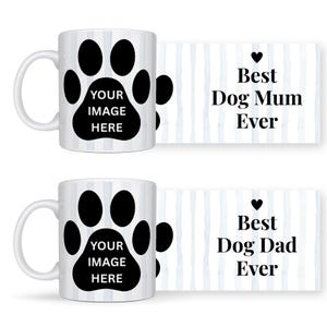 May include: Two white ceramic mugs with black paw prints and the text "YOUR IMAGE HERE". Beside each mug is a card with the text "Best Dog Mum Ever" and "Best Dog Dad Ever" with a heart symbol.