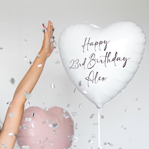 May include: A white heart-shaped balloon with the text "Happy 23rd Birthday Alex" written in black script.