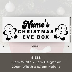 May include: A white rectangular sign with the text "Name's CHRISTMAS EVE BOX" in black, with gingerbread man illustrations. Available in two sizes: 15cm wide x 5cm high or 20cm wide x 6.7cm high. Festive holiday decor.