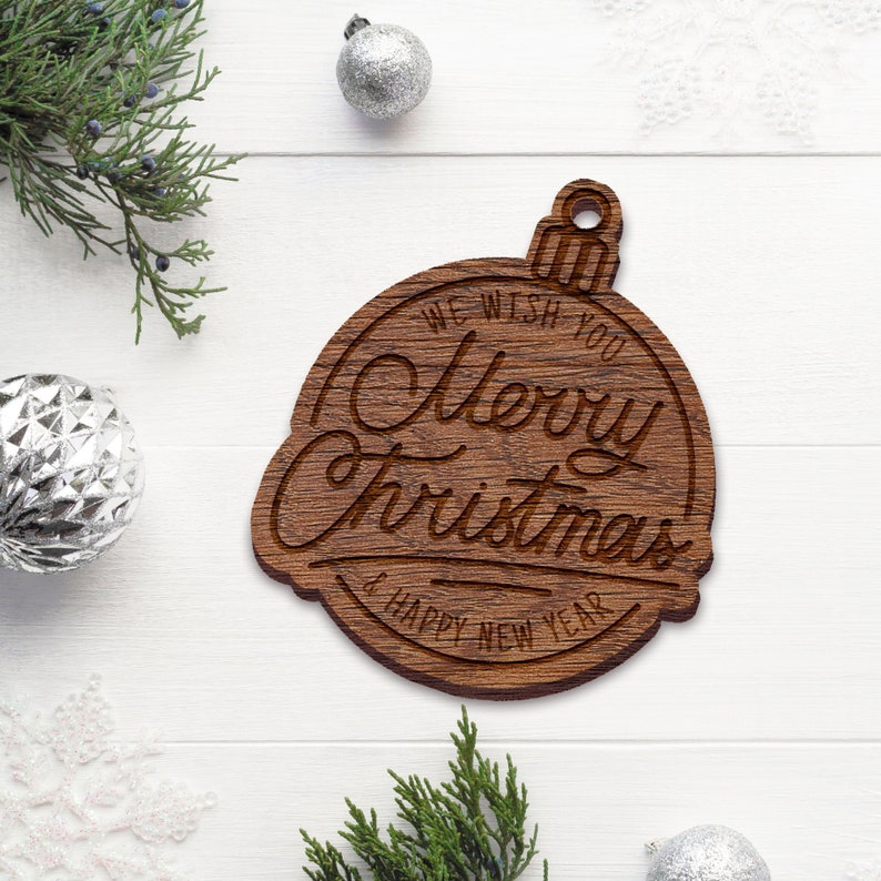 May include: Wooden Christmas ornament shaped like a bell with the text "We wish you Merry Christmas & Happy New Year" engraved on it.